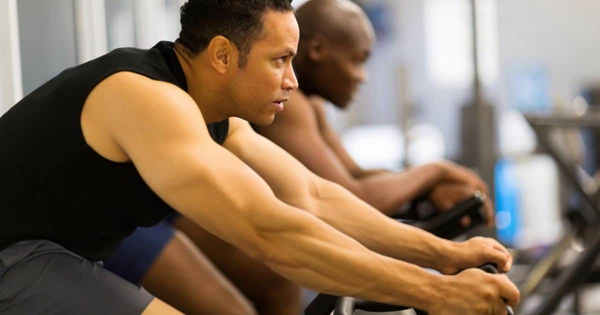 Men cycling on stationary bikes