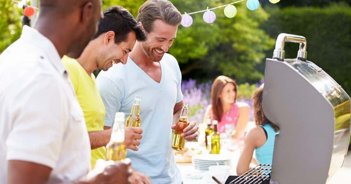 Friends gathered around an outdoor grill