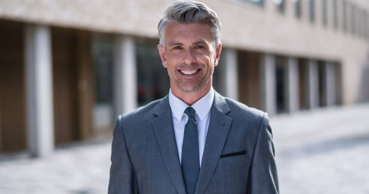 Smiling businessman in a gray suit