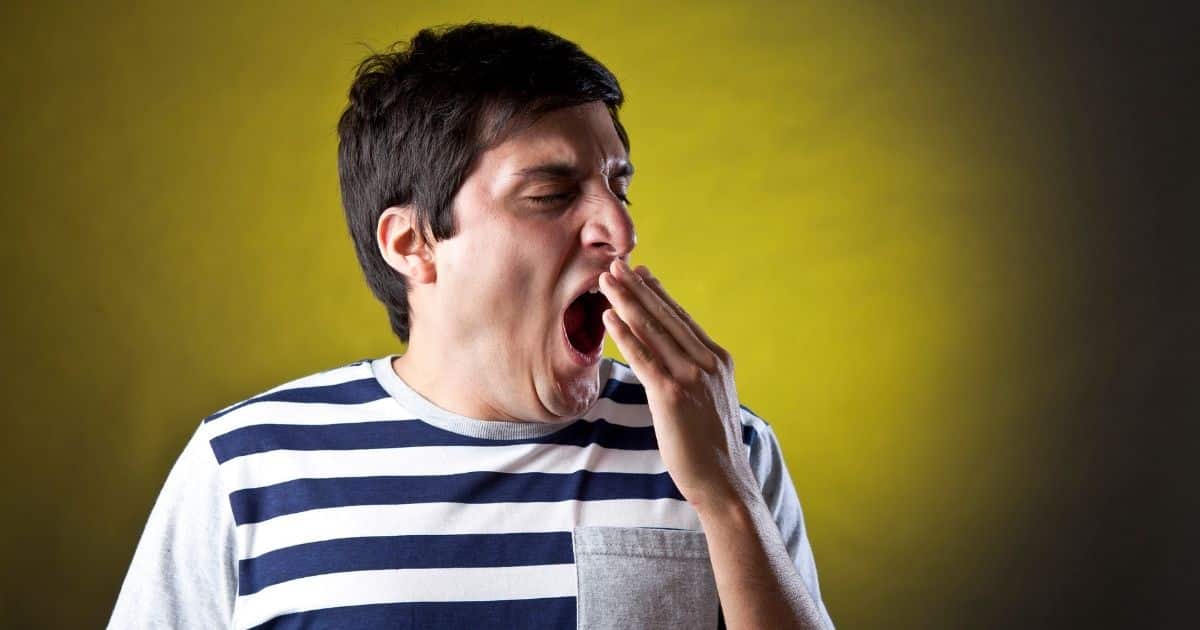 Tired man yawning