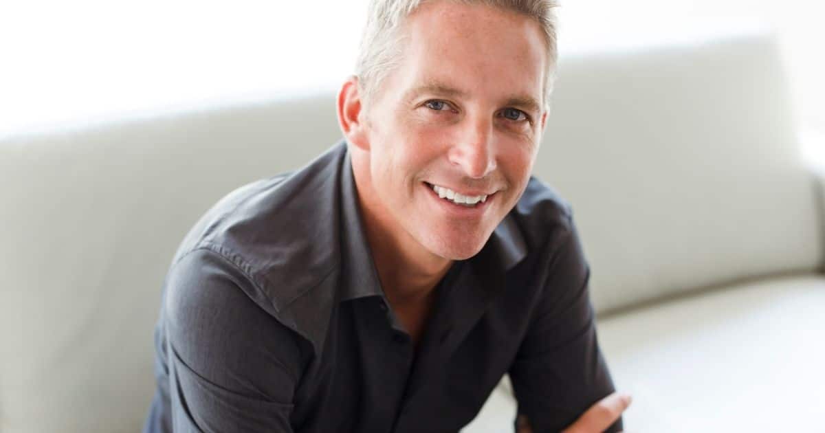 Smiling older man on a couch