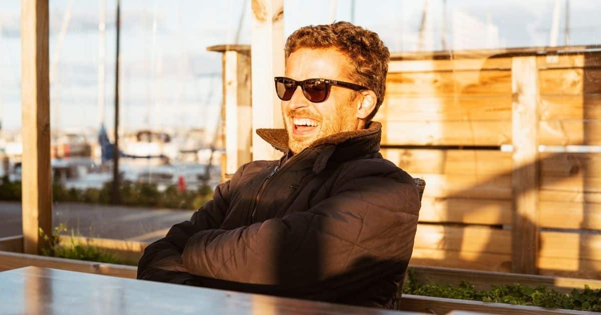 Man wearing sunglasses on a sunny patio