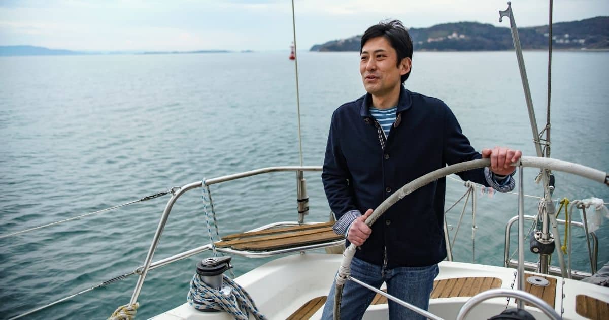 Man standing on a sailboat