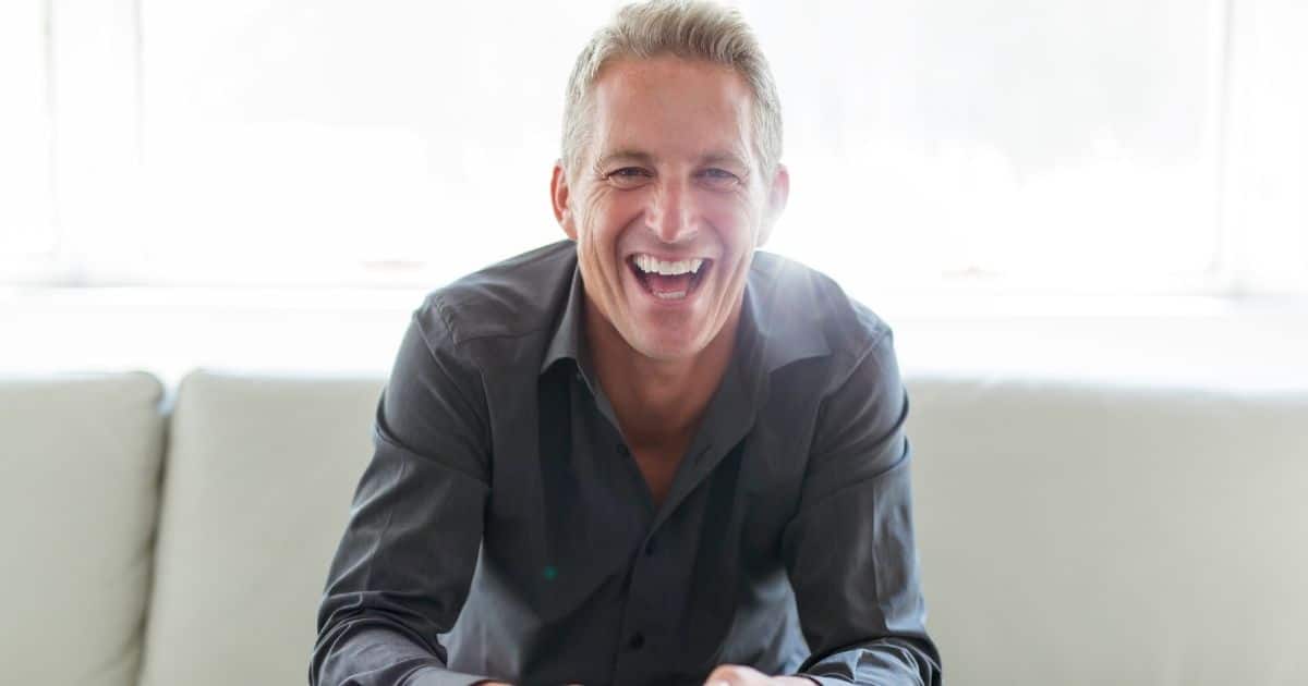 Smiling older man sitting on a couch