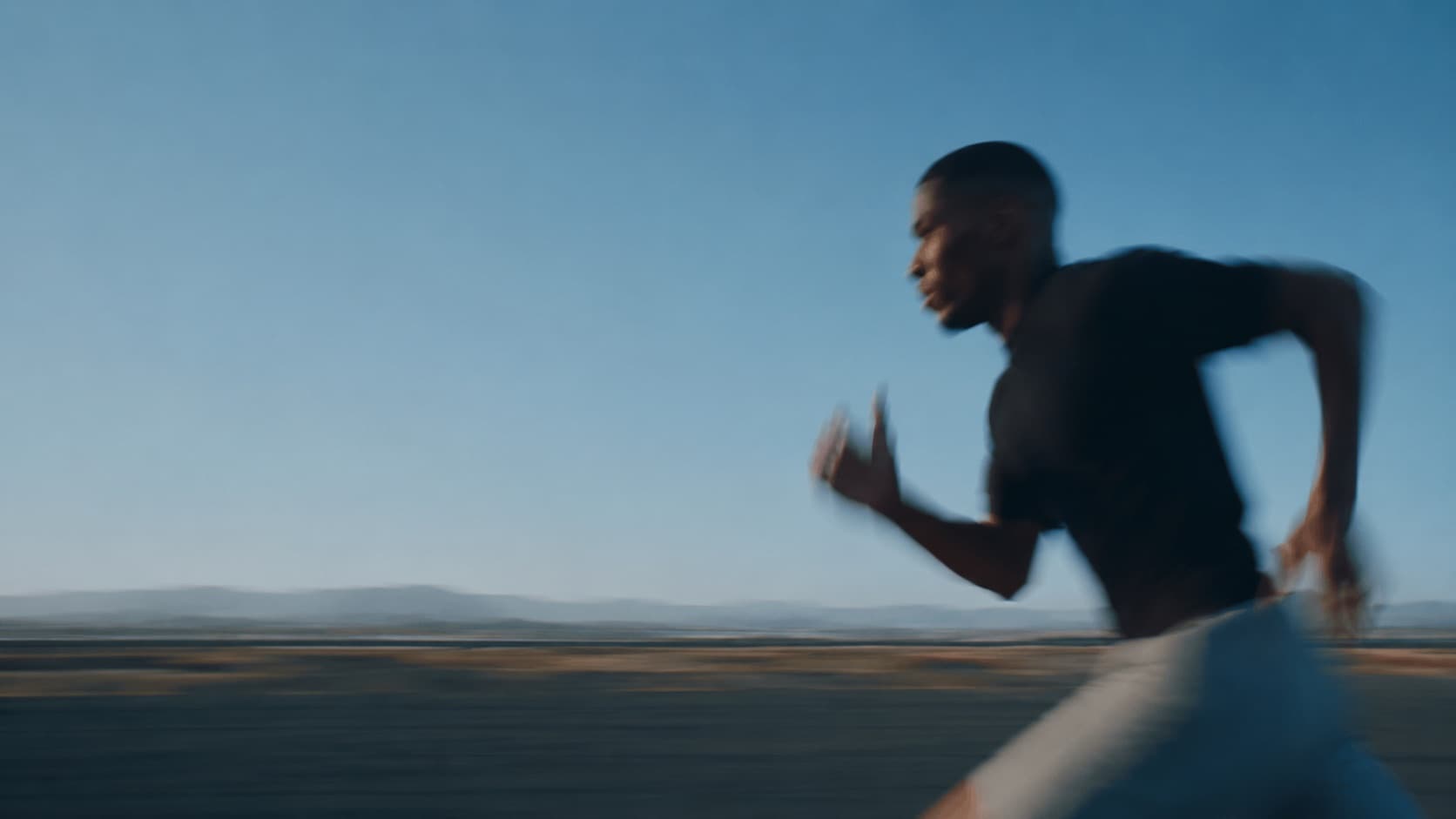 Man running at dawn, mid-stride