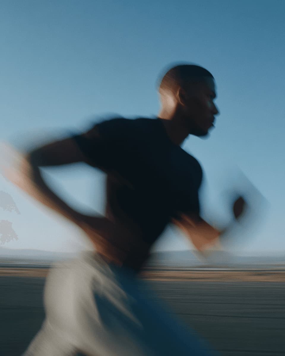 Man running at dawn, mid-stride