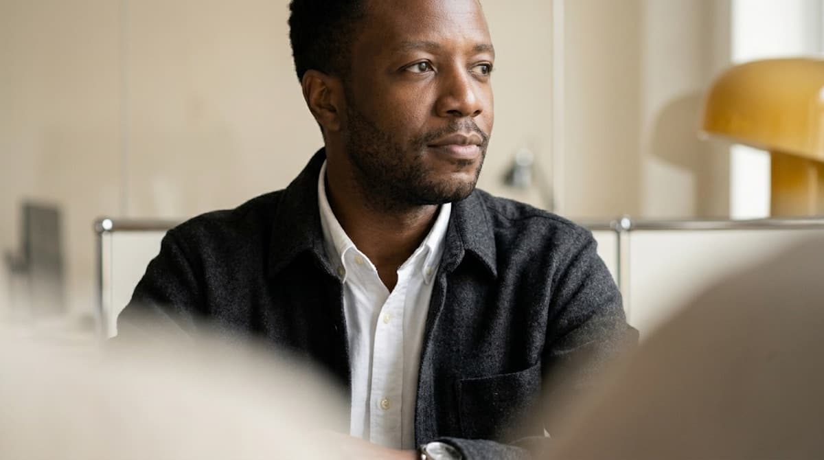 Man looking thoughtfully outdoors