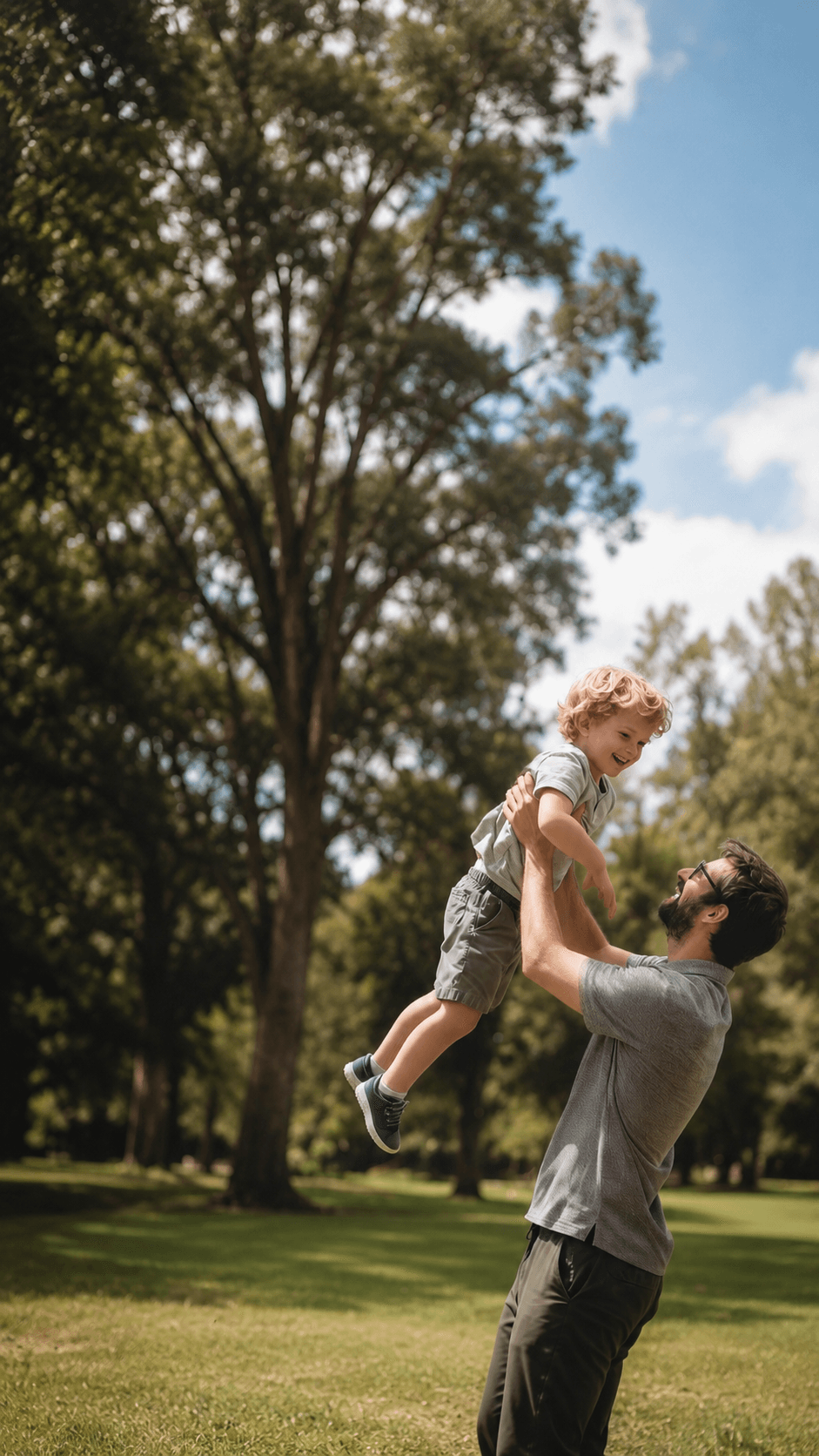 Father lifting his son outdoors after optimizing his health at a Mantality Health clinic