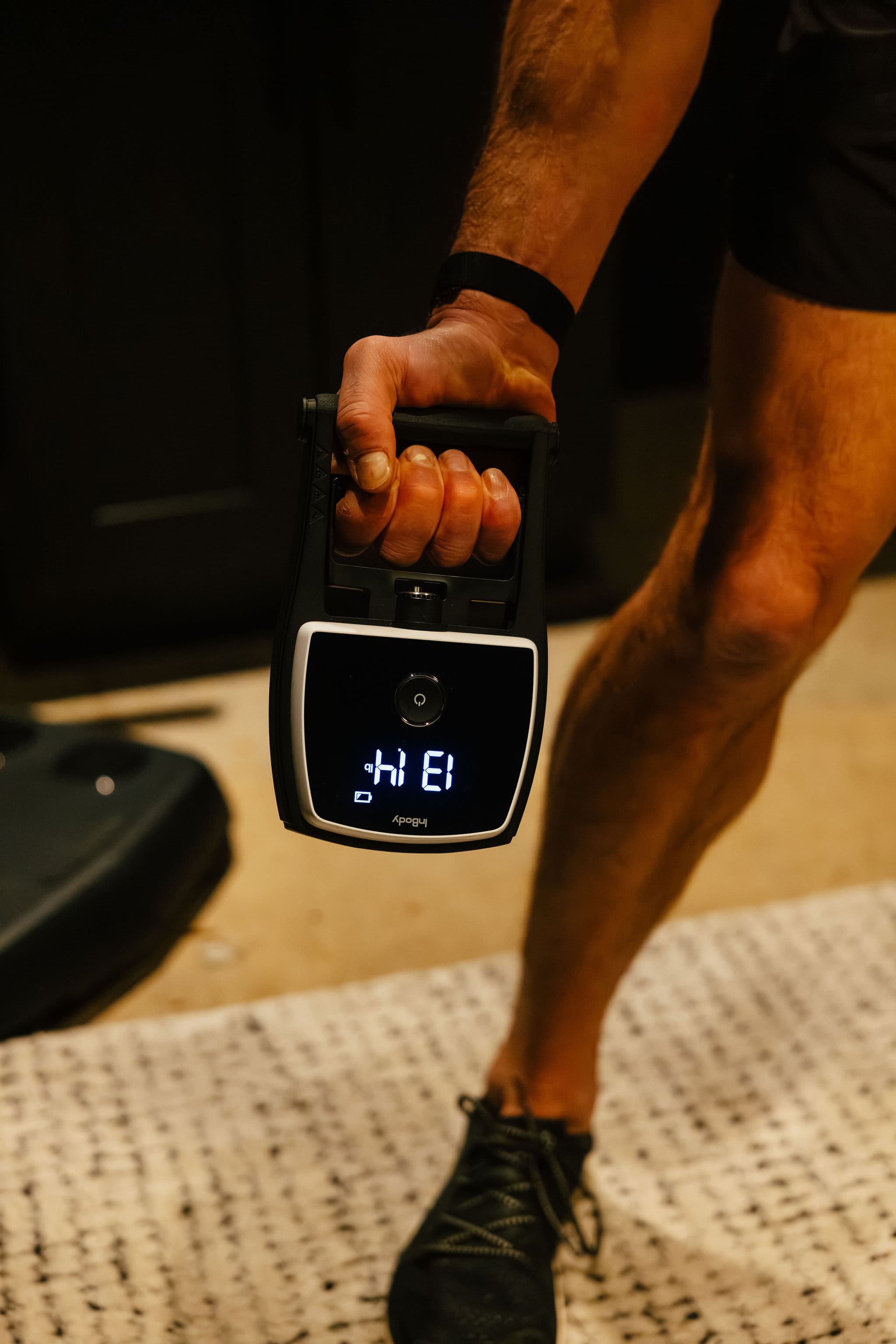 Patient gripping a hand dynamometer for the functional strength test