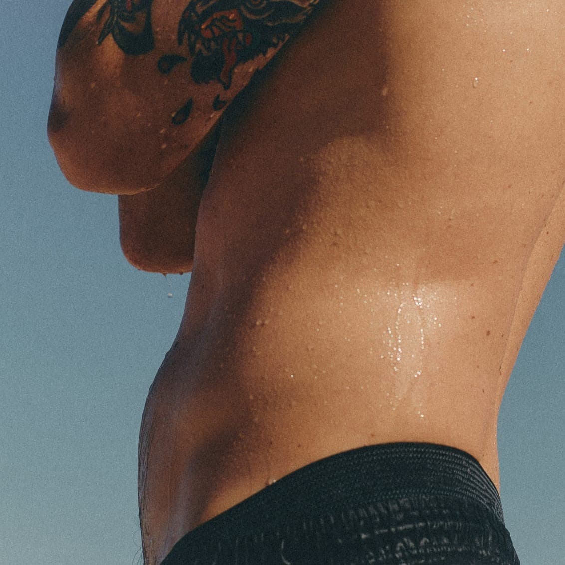 Man noticing loss of muscle mass, a common sign of low testosterone