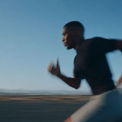 Man running along an open shoreline