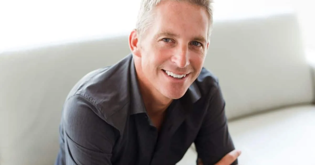Smiling older man on a couch