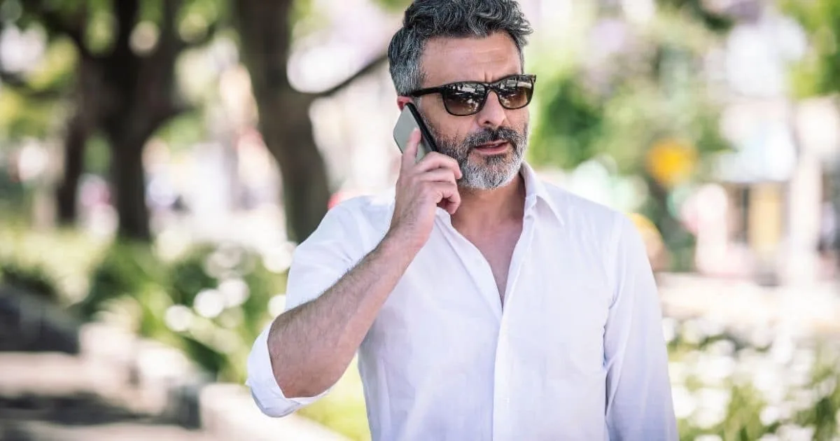 Man talking on a phone outdoors