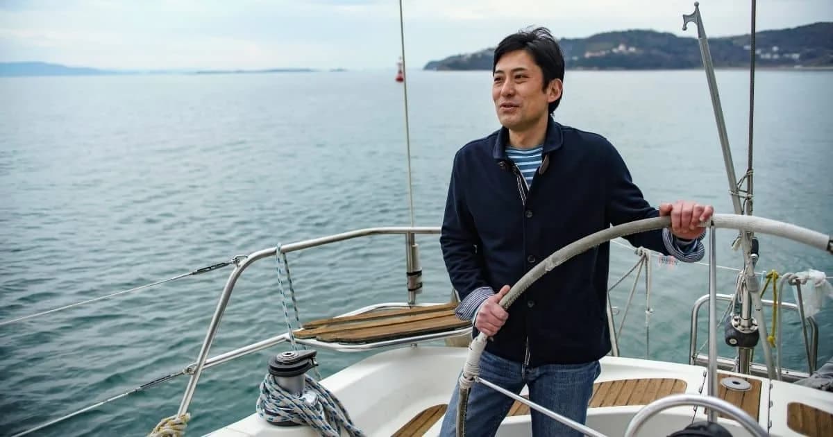 Man standing on a sailboat