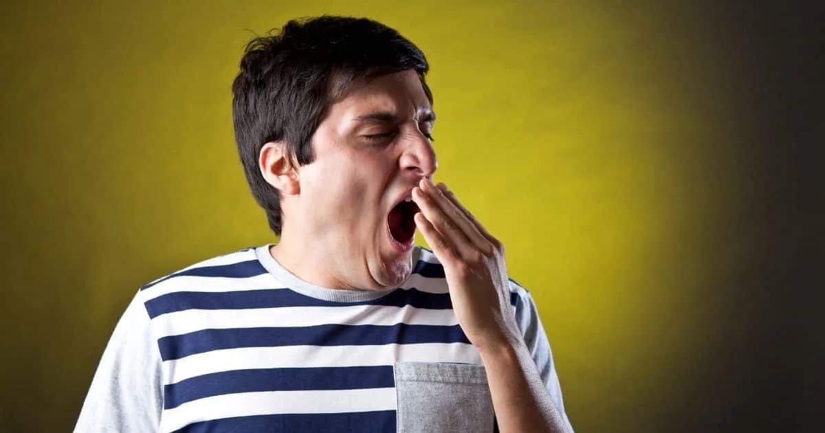 Tired man yawning