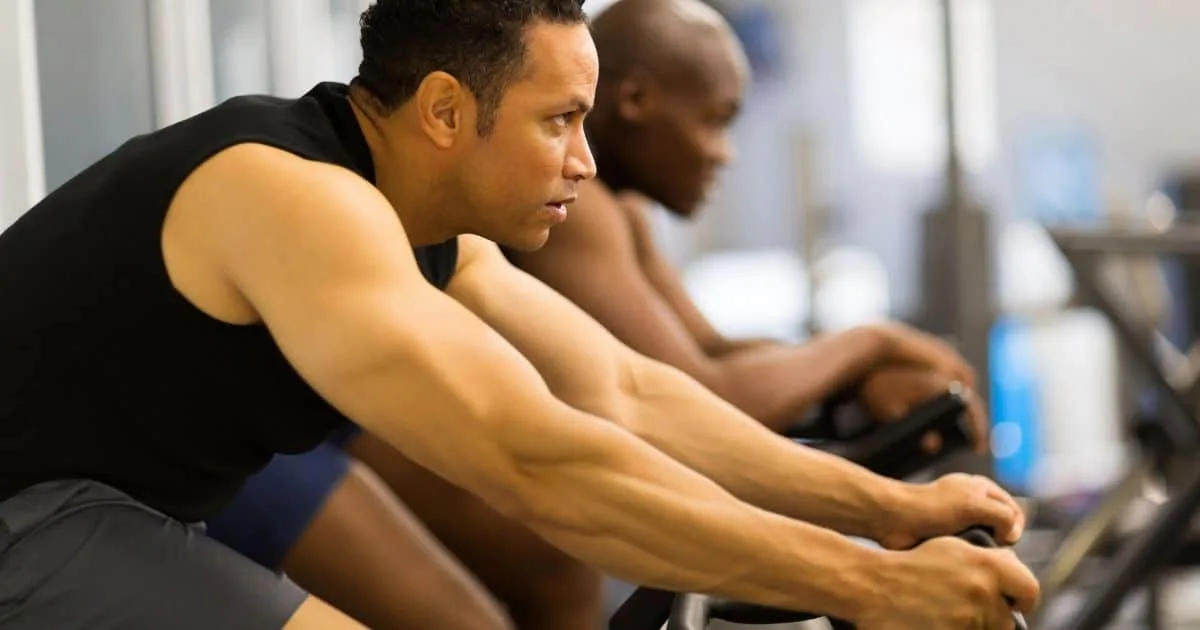 Men cycling on stationary bikes