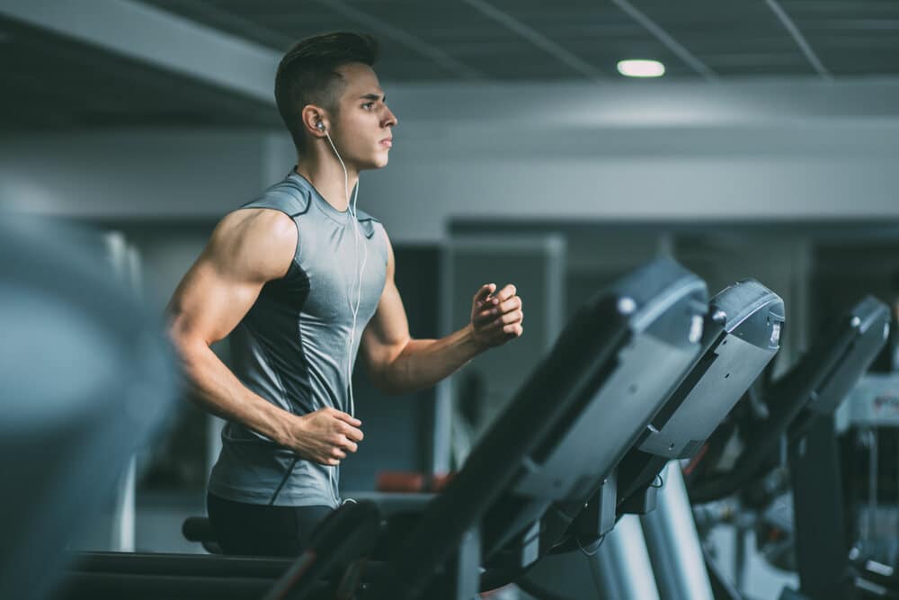 A muscular man on a treadmill