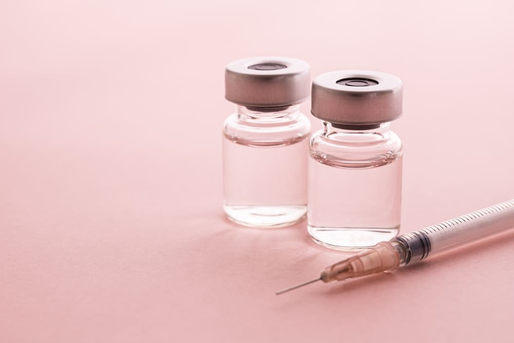 A syringe and two bottles