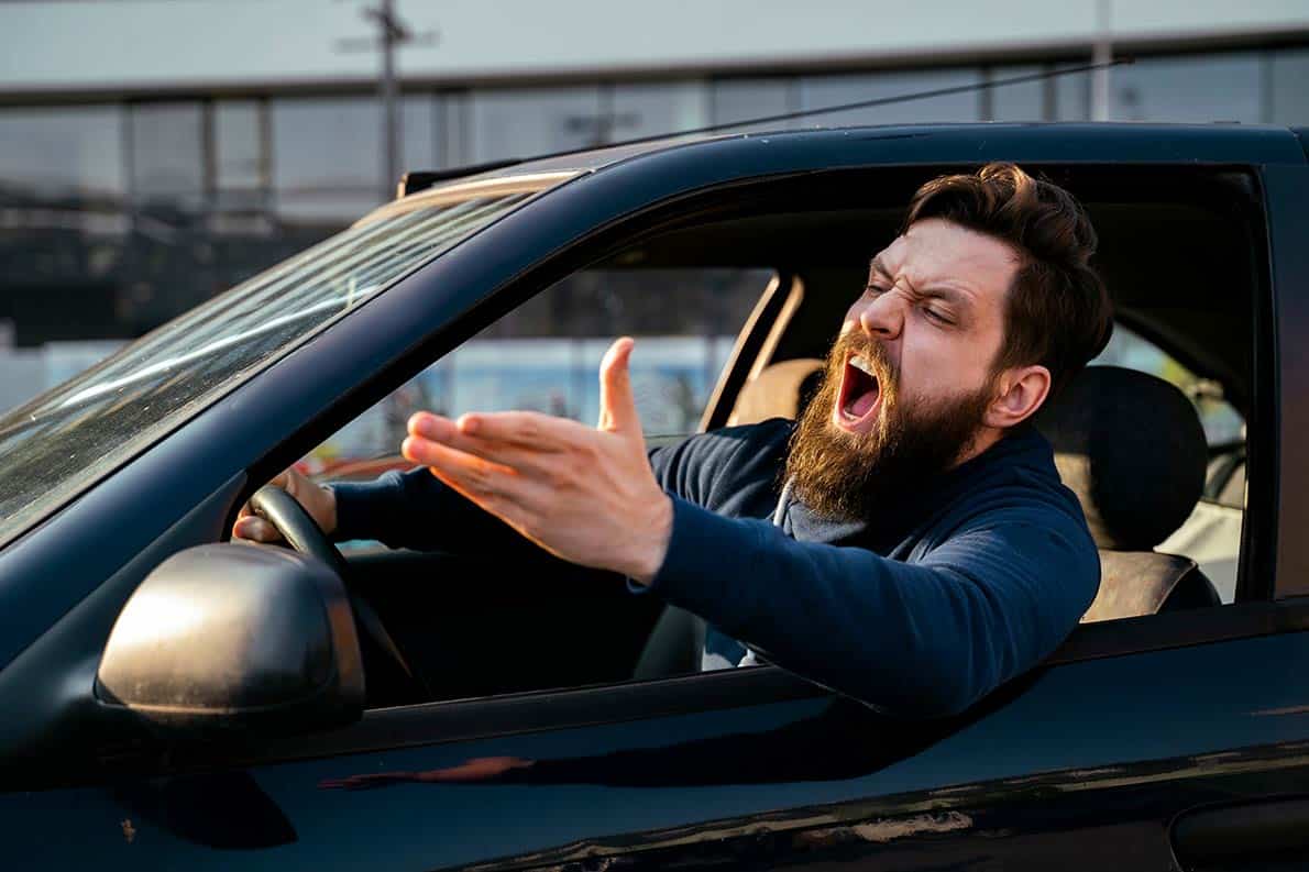 An angry man yelling in a car