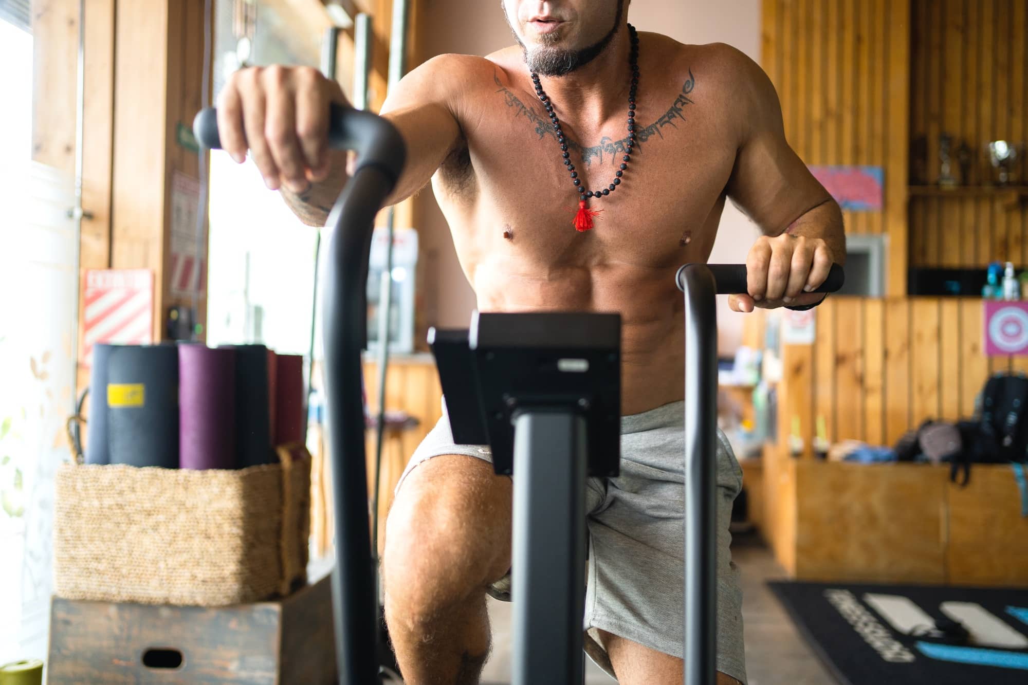 Man using an air bike on a gym